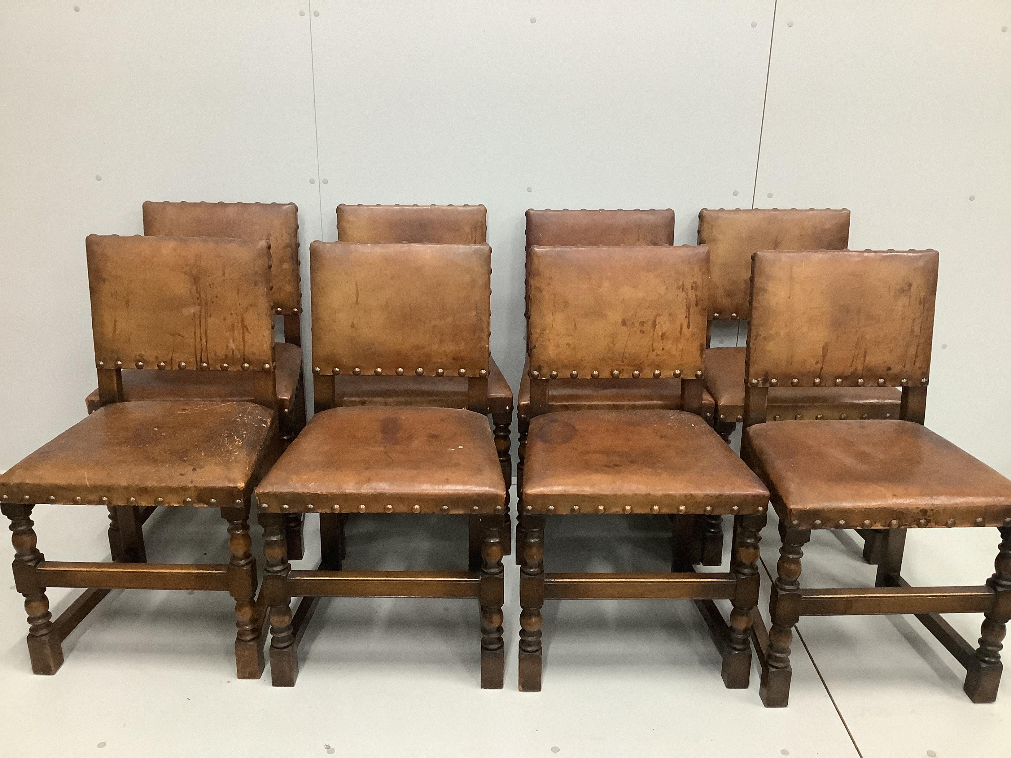 An 18th century style rectangular oak refectory dining table, width 183cm, depth 83cm, height 77cm and eight studded leather chairs